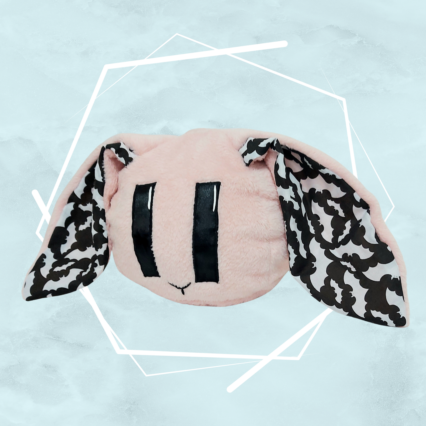 Pale pink bunny plushie with bats