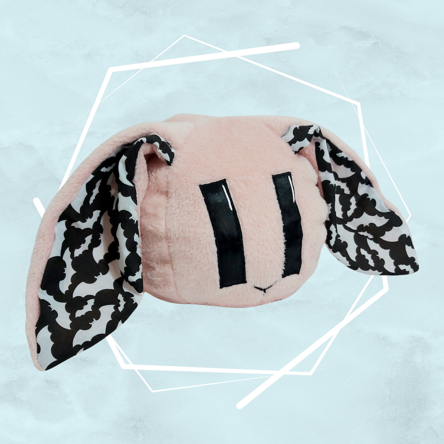 Pale pink bunny plushie with bats