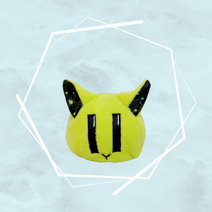 A kawaii, small green kitty plushie with black spider patterns on its ears, made uniquely by Freya's Madpeak