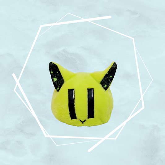 A kawaii, small green kitty plushie with black spider patterns on its ears, made uniquely by Freya's Madpeak