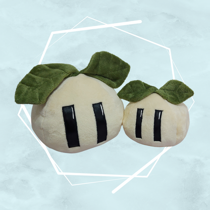 Unique, artist made plush toys resembling a pair of blobs with green leaves like sprouts