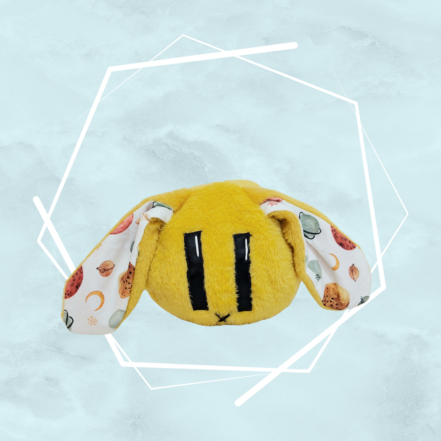 Soft plush creature featuring original art by Freyas Madpeak, in yellow color and planets pattern