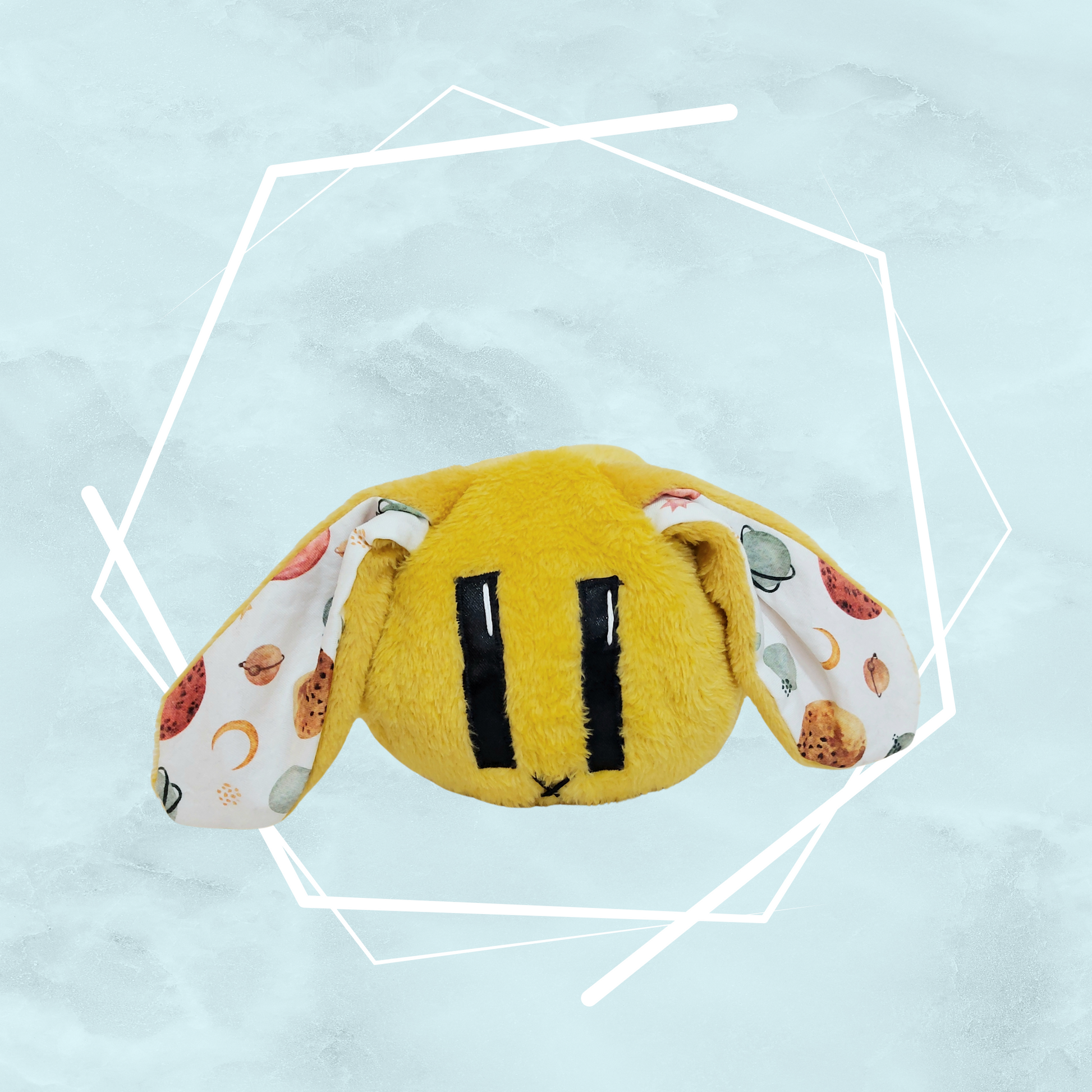 Soft plush creature featuring original art by Freyas Madpeak, in yellow color and planets pattern