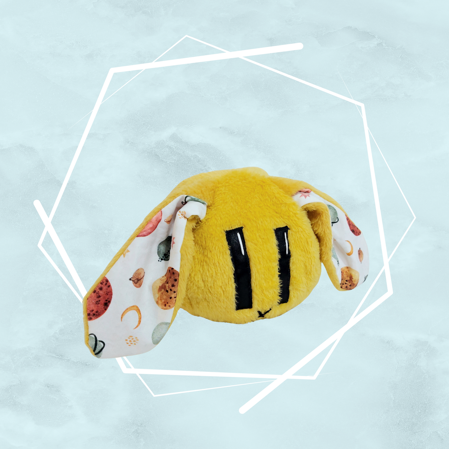 Small yellow bunny plushie with colorful planets