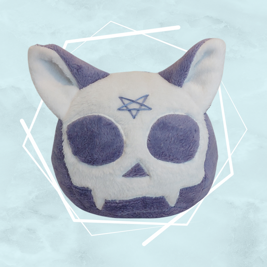 A plushie of a purple cat skull with a pentagram design, made of soft fabric, intended for Halloween season.