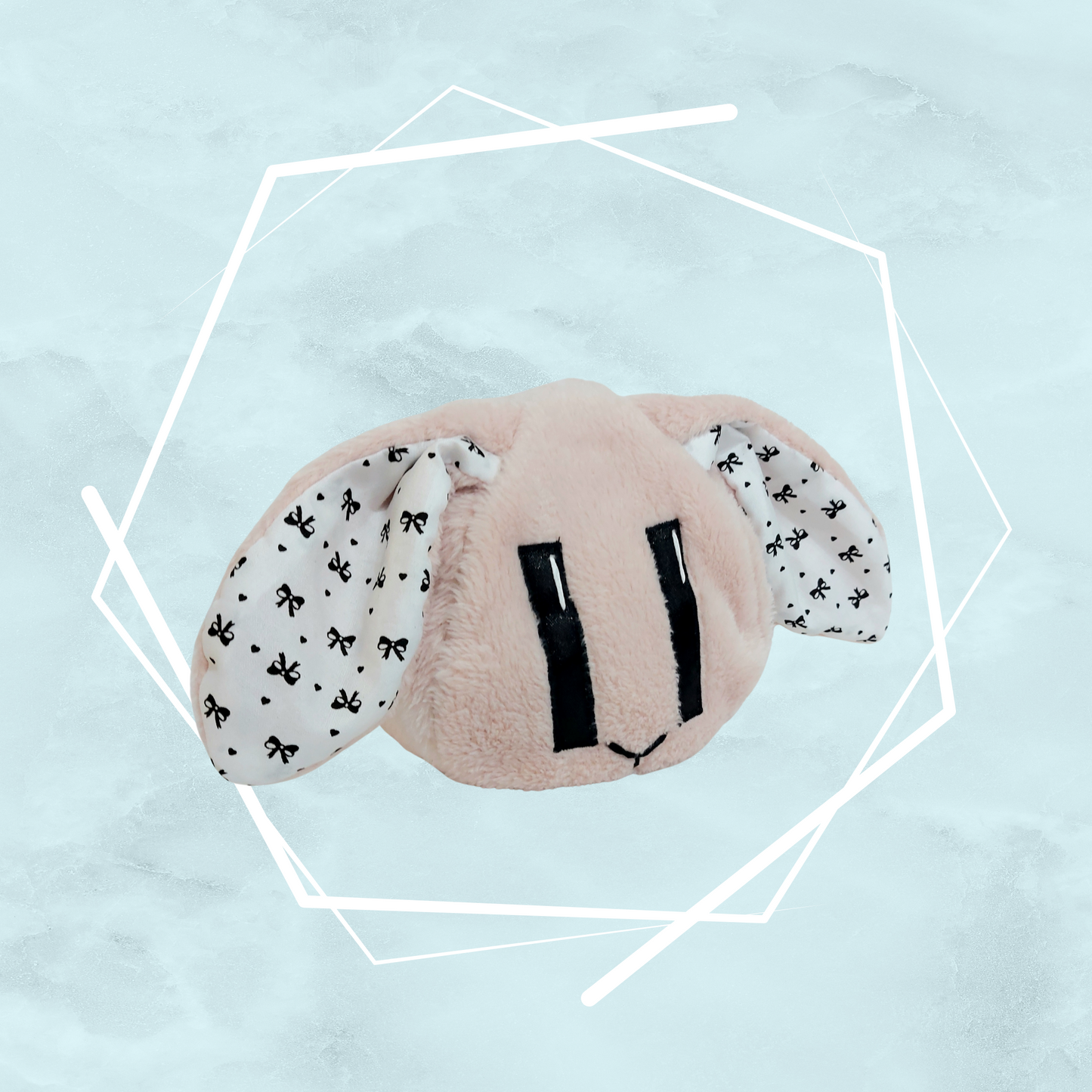 Small pale pink bunny plushie with ribbons