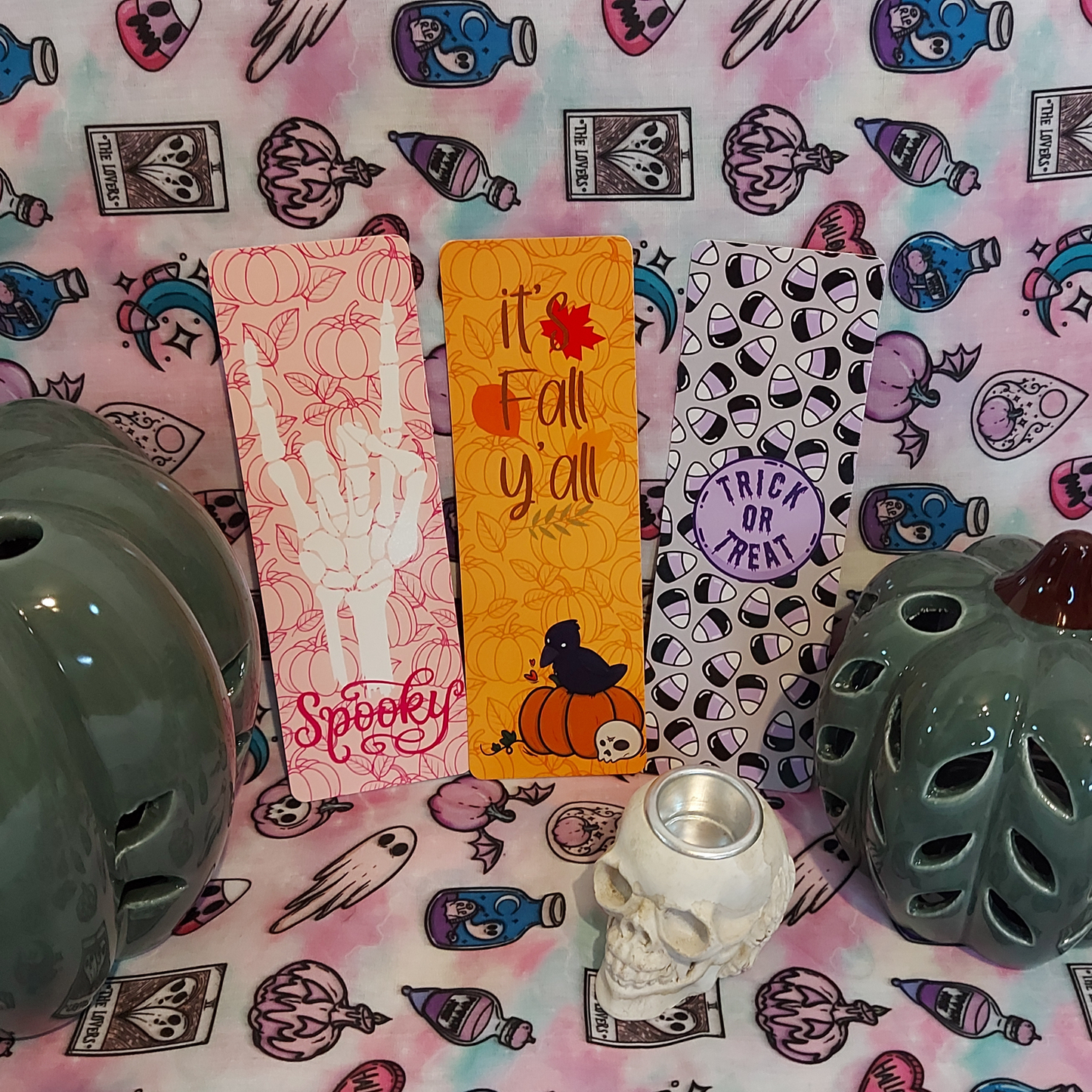 Three Halloween-themed bookmarks with spooky and autumn themes, made for book lovers