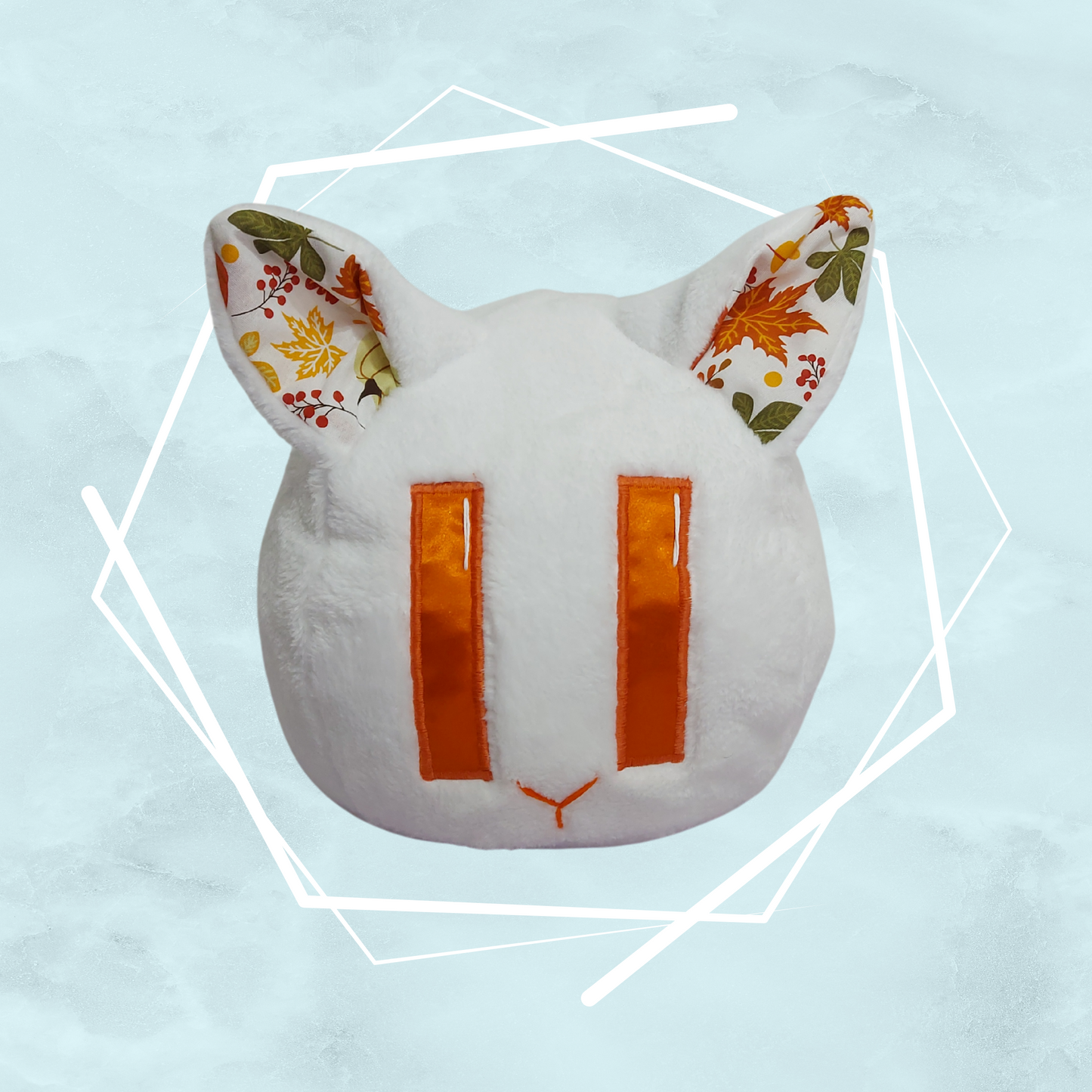 Hand made soft, cat-shaped plush toy with floral and leafy patterns and quirky design